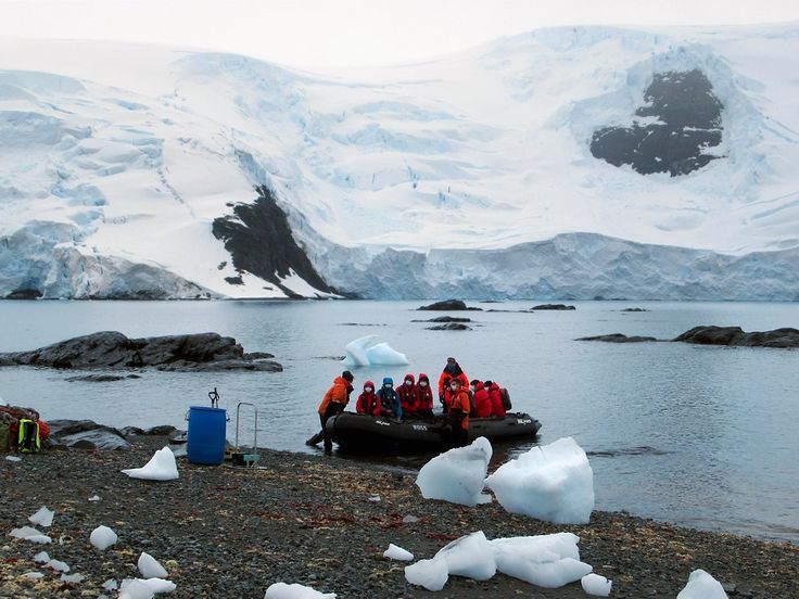 Zodiac landing on Antarctic shore with expedition passengers